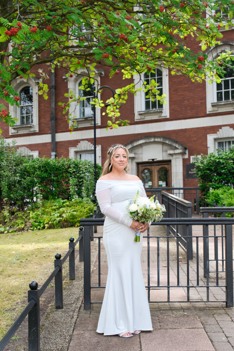 bride outside the stockport registry office just before getting married 