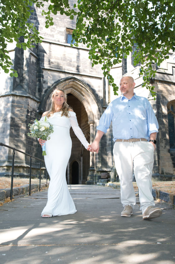A bride and room on the grounds of Saint Mary's Church Sandbach