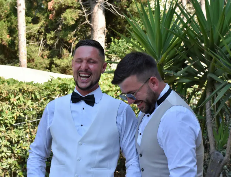 groom and best man having a laugh 