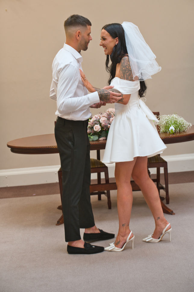 Bride and groom share a funny moment just getting married in the sir A Brummell Thomas room at Stockport Town hall  