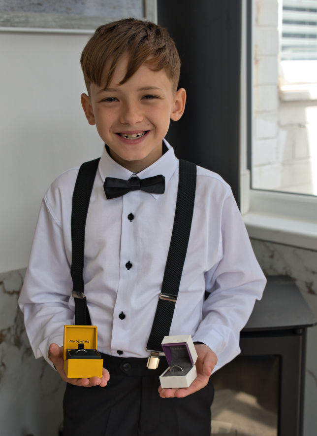 The bride and grooms son holds the rings before going to St George's Church in London Road Stockport to watch his mum and dad get married