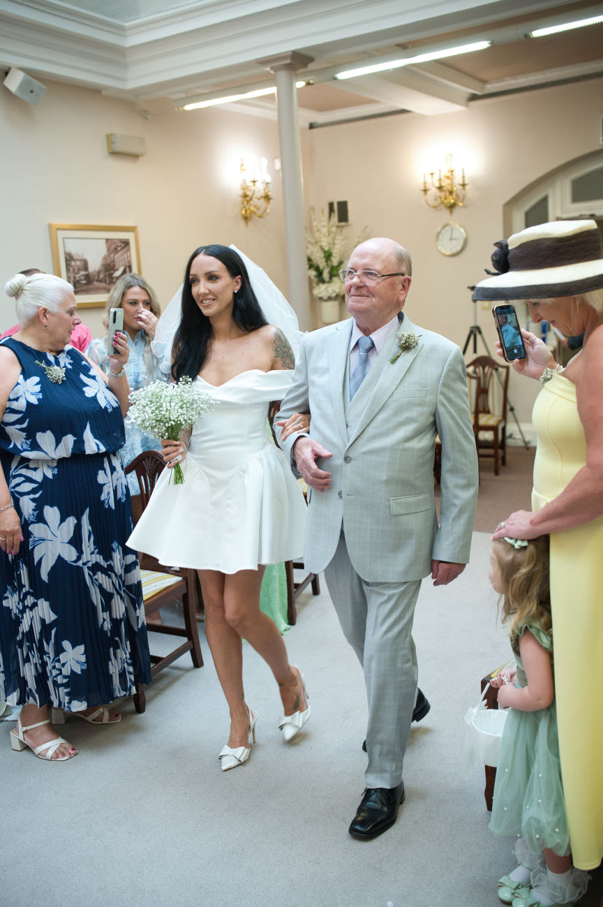 Stockport town hall wedding. grandfather walks bride down the isle