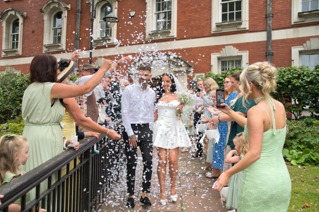 Stockport town hall wedding. the bride and  groom leave the ceremony 