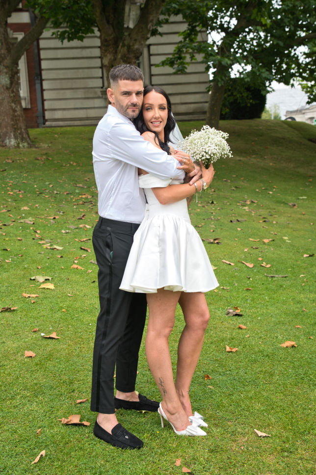 Stockport town hall wedding. bride and groom pose for pictures out side the town hall 